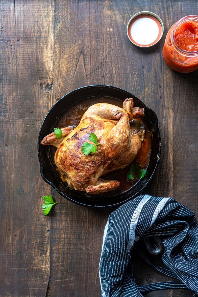 A roast chicken in a cast-iron skillet